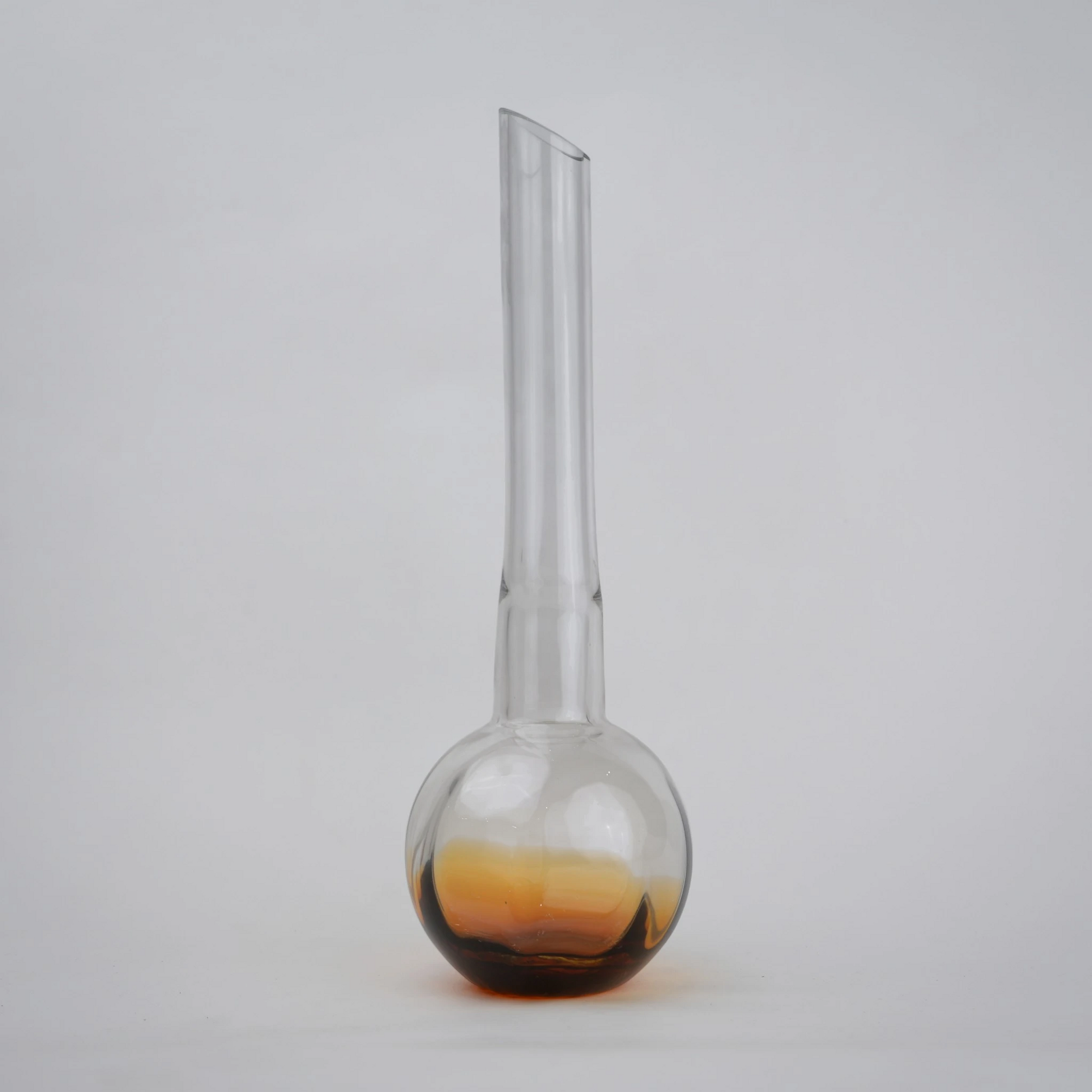 Glass vase with spherical base and elongated cylindrical neck designed for single stem floral arrangements