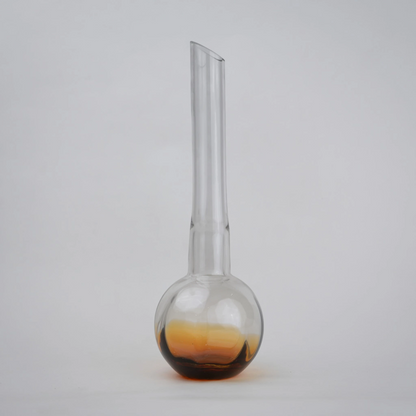 Glass vase with spherical base and elongated cylindrical neck designed for single stem floral arrangements