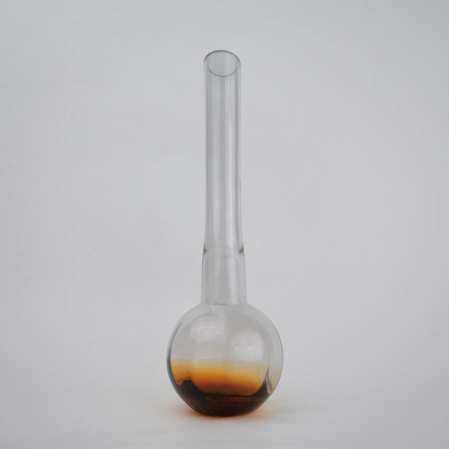 Glass vase with spherical base and elongated cylindrical neck designed for single stem floral arrangements