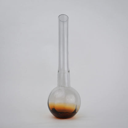 Glass vase with spherical base and elongated cylindrical neck designed for single stem floral arrangements