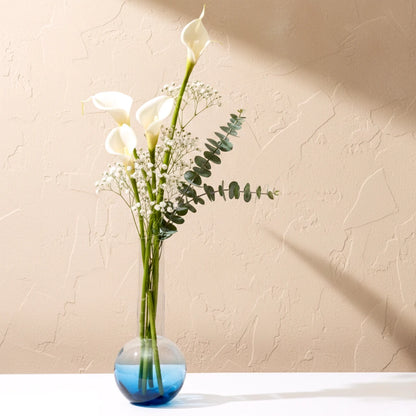 Glass vase with spherical base and elongated cylindrical neck designed for single stem floral arrangements