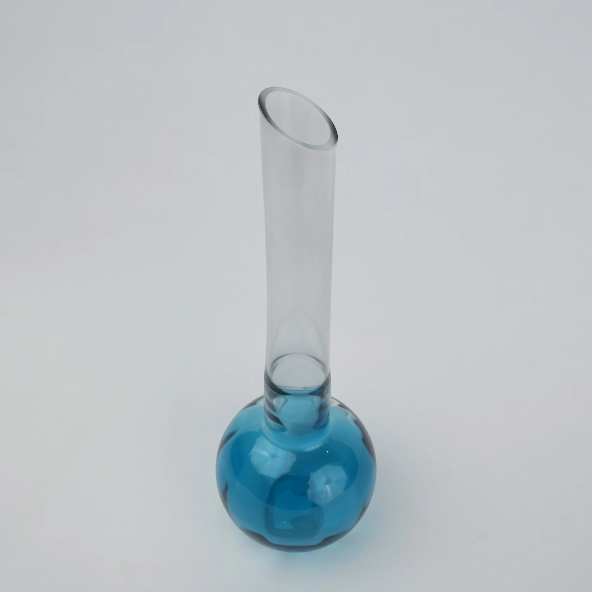 Glass vase with spherical base and elongated cylindrical neck designed for single stem floral arrangements