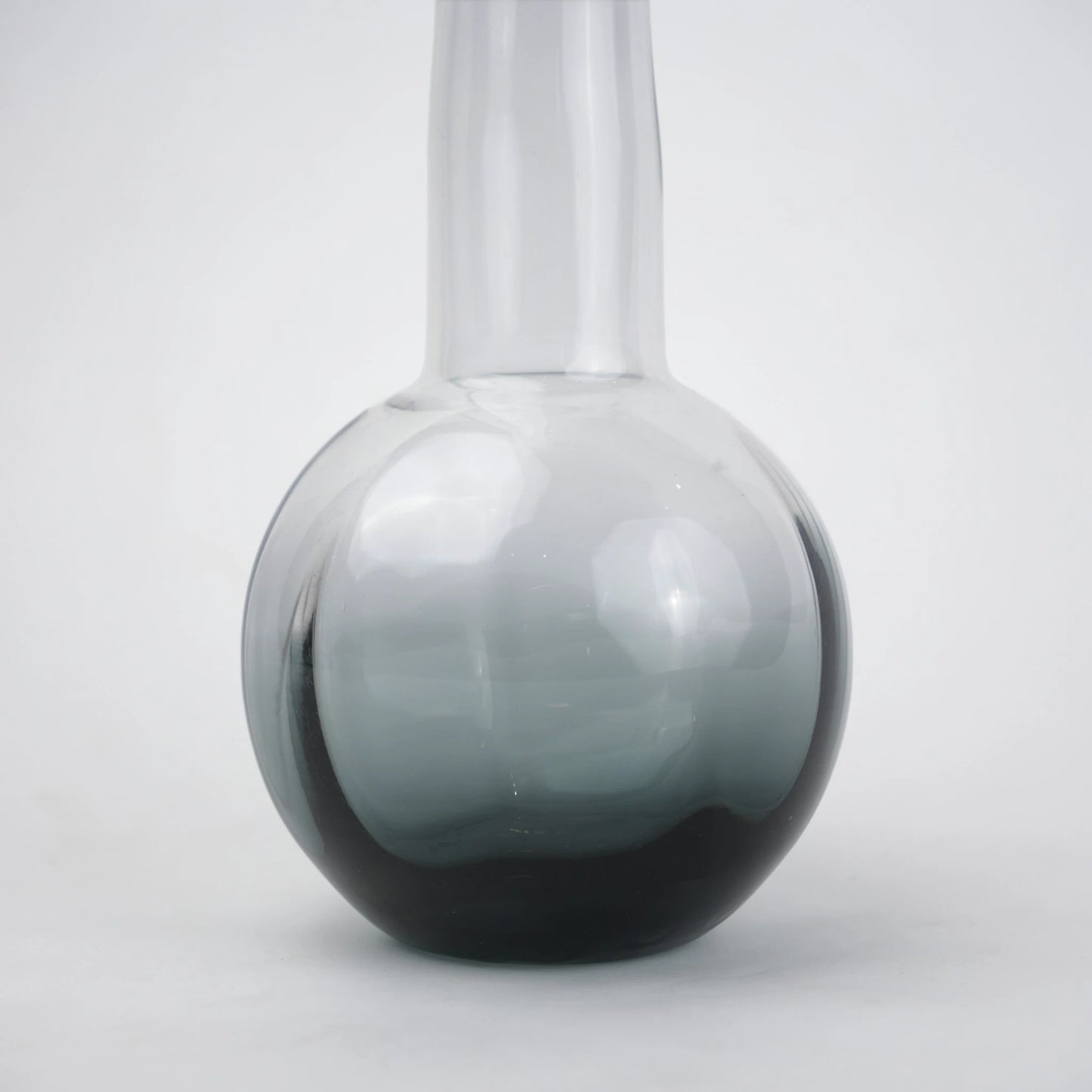 Glass vase with spherical base and elongated cylindrical neck designed for single stem floral arrangements