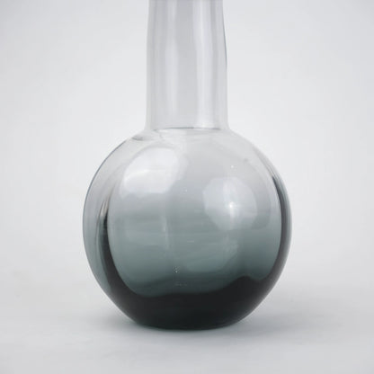 Glass vase with spherical base and elongated cylindrical neck designed for single stem floral arrangements