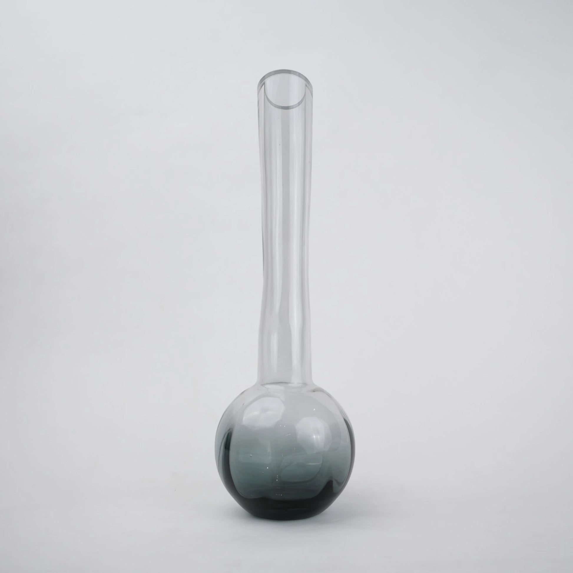 Glass vase with spherical base and elongated cylindrical neck designed for single stem floral arrangements