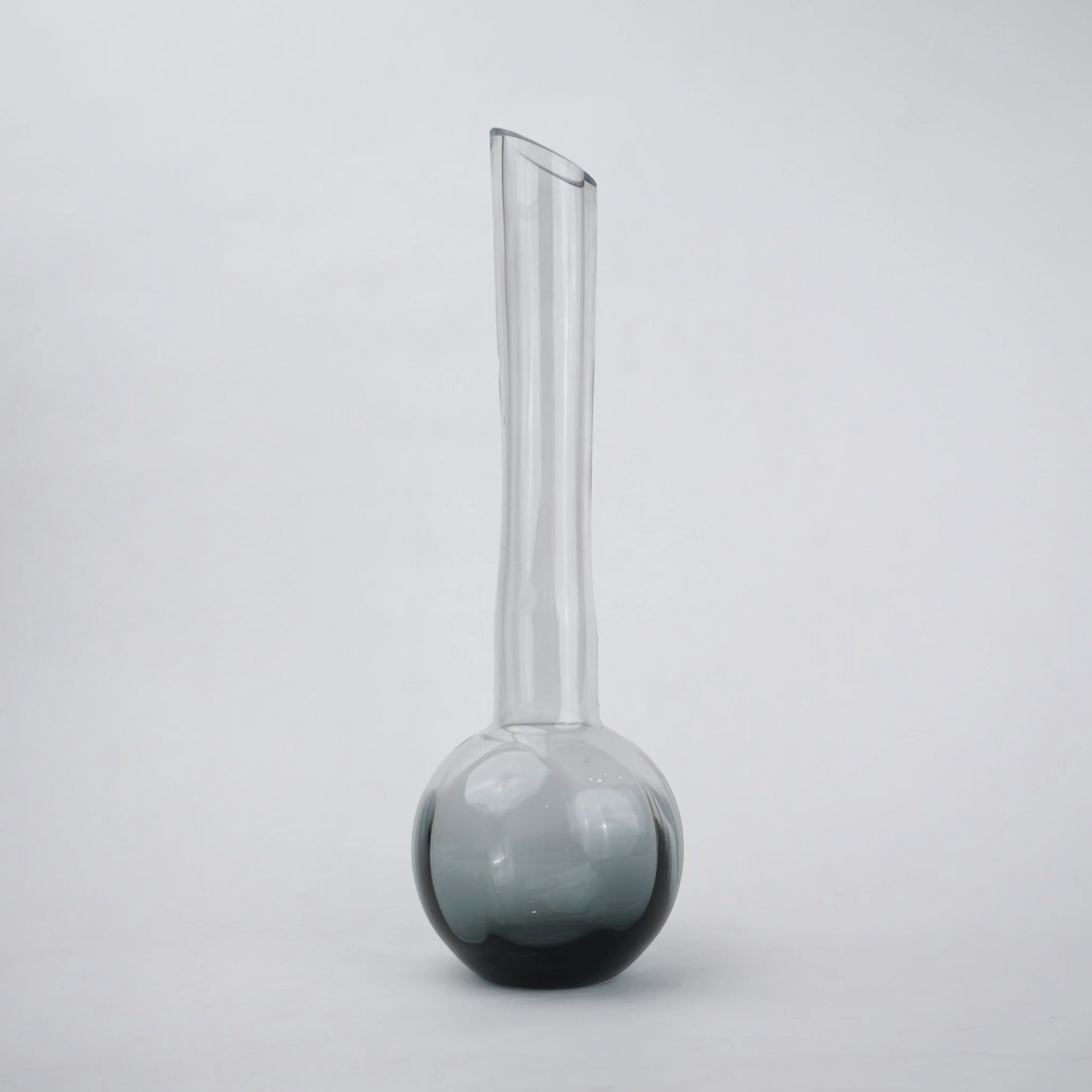 Glass vase with spherical base and elongated cylindrical neck designed for single stem floral arrangements