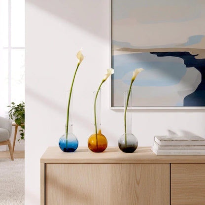 Glass vase with spherical base and elongated cylindrical neck designed for single stem floral arrangements