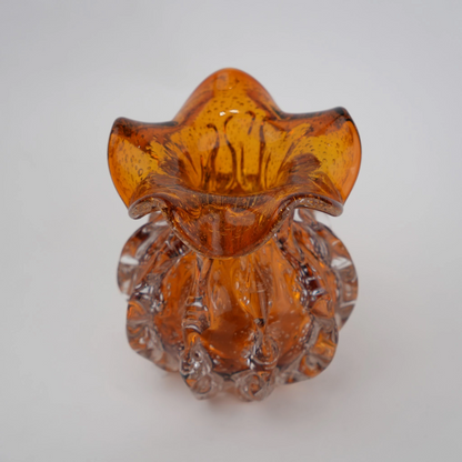 Sculptural amber-toned art glass vase with textured molten-inspired silhouette.