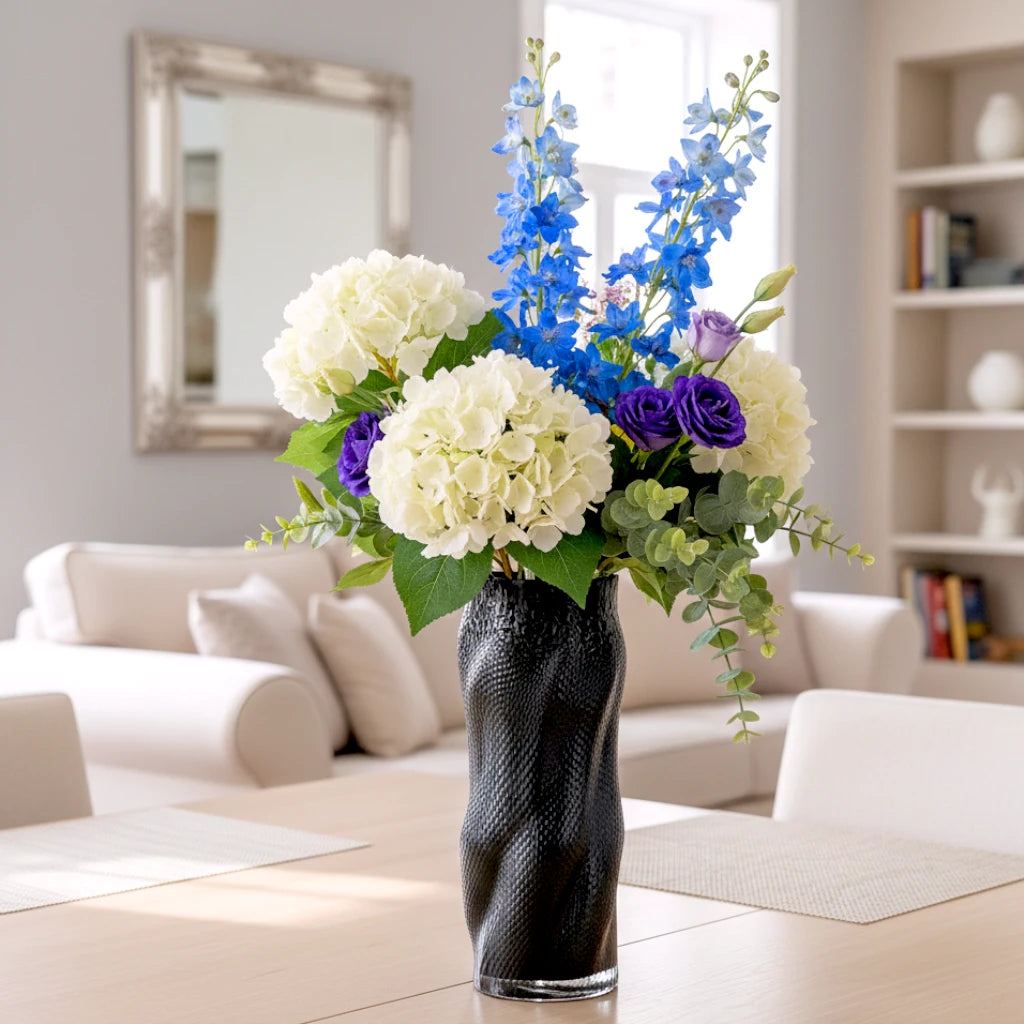 Textured art glass vase with flowing sculptural form and dimensional surface detailing