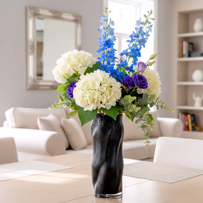 Textured art glass vase with flowing sculptural form and dimensional surface detailing
