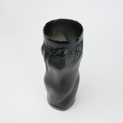 Textured art glass vase with flowing sculptural form and dimensional surface detailing