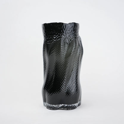 Textured art glass vase with flowing sculptural form and dimensional surface detailing