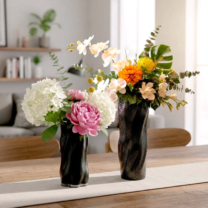 Textured art glass vase with flowing sculptural form and dimensional surface detailing