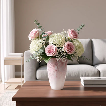 Frosted white glass vase with soft blush marble veining and smooth tapered silhouette.