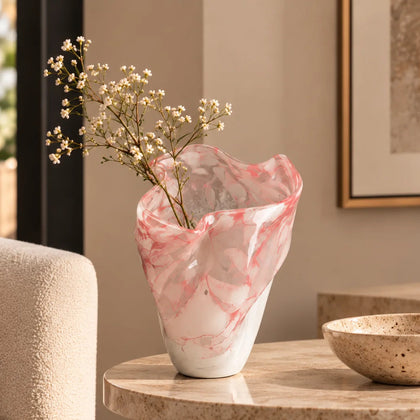 Frosted white glass vase with soft blush marble veining and smooth tapered silhouette.