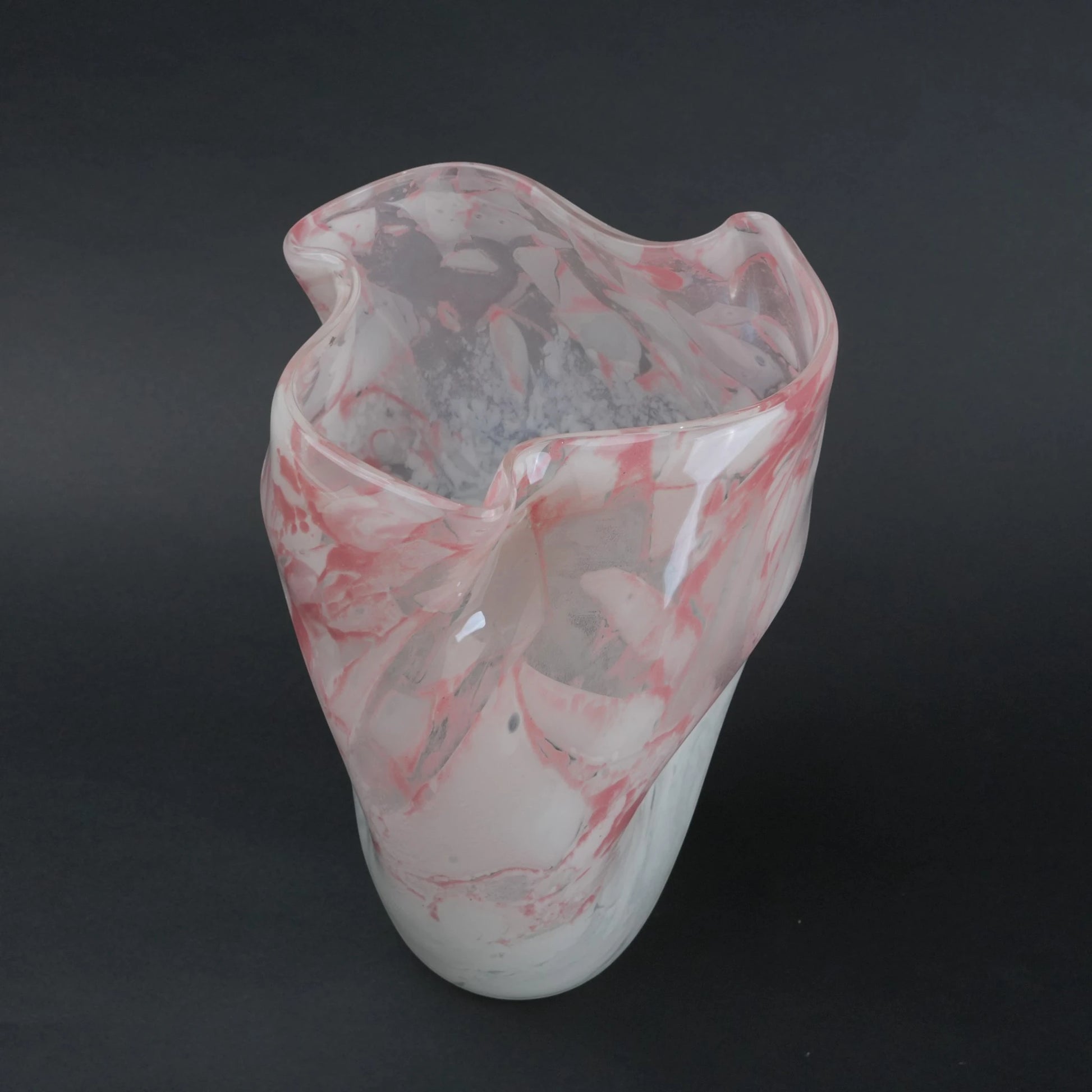 Frosted white glass vase with soft blush marble veining and smooth tapered silhouette.