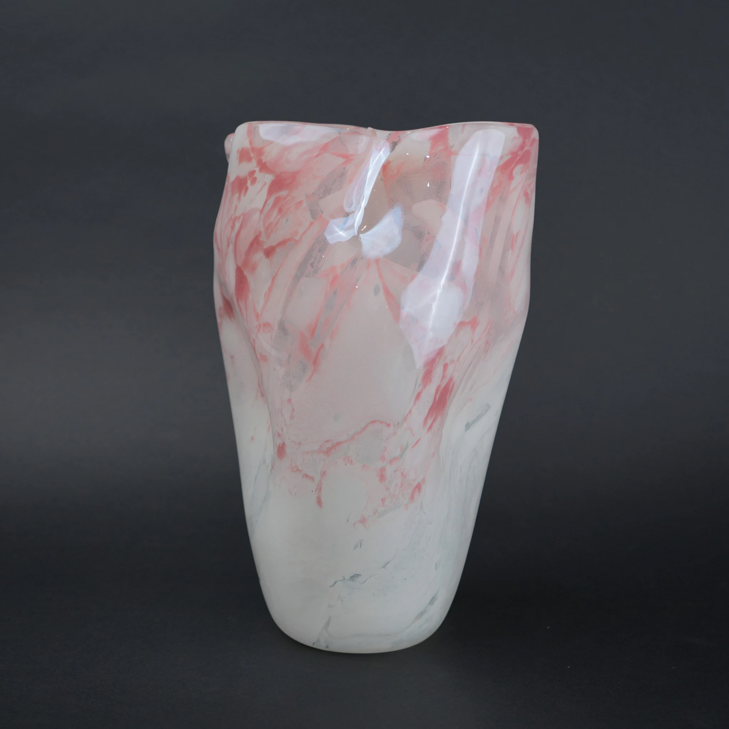 Frosted white glass vase with soft blush marble veining and smooth tapered silhouette.