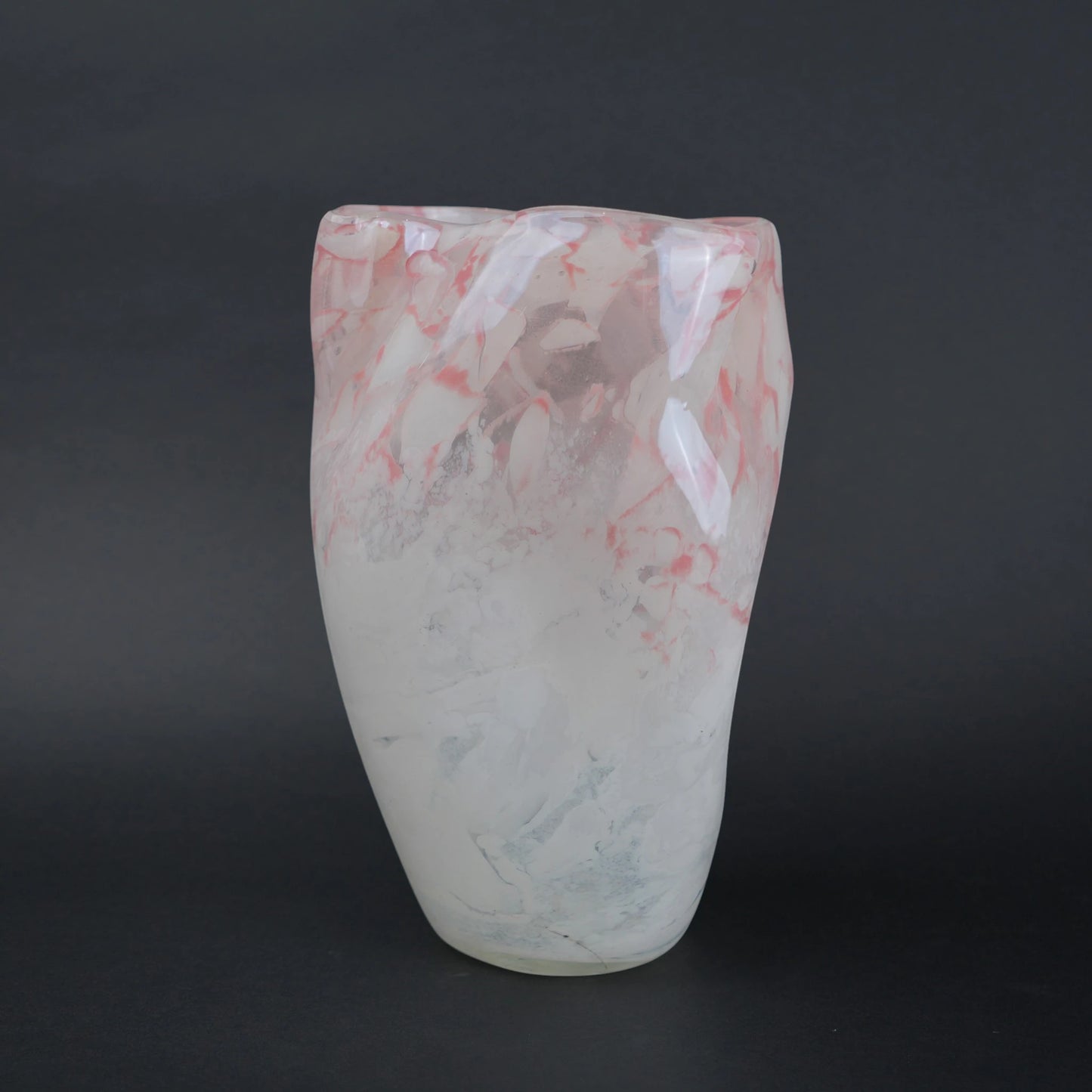 Frosted white glass vase with soft blush marble veining and smooth tapered silhouette.