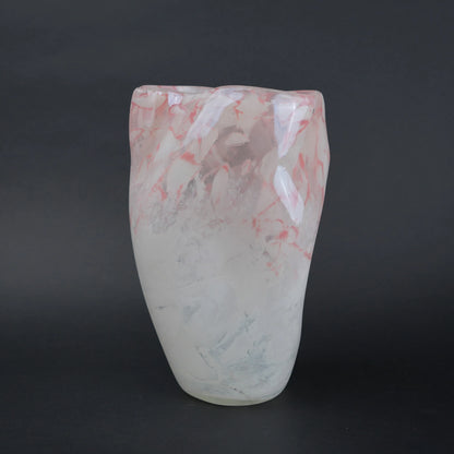 Frosted white glass vase with soft blush marble veining and smooth tapered silhouette.