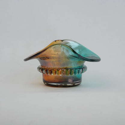 Dual-tone aqua and amber glass vase with sculptural wave-shaped rim and rounded base.