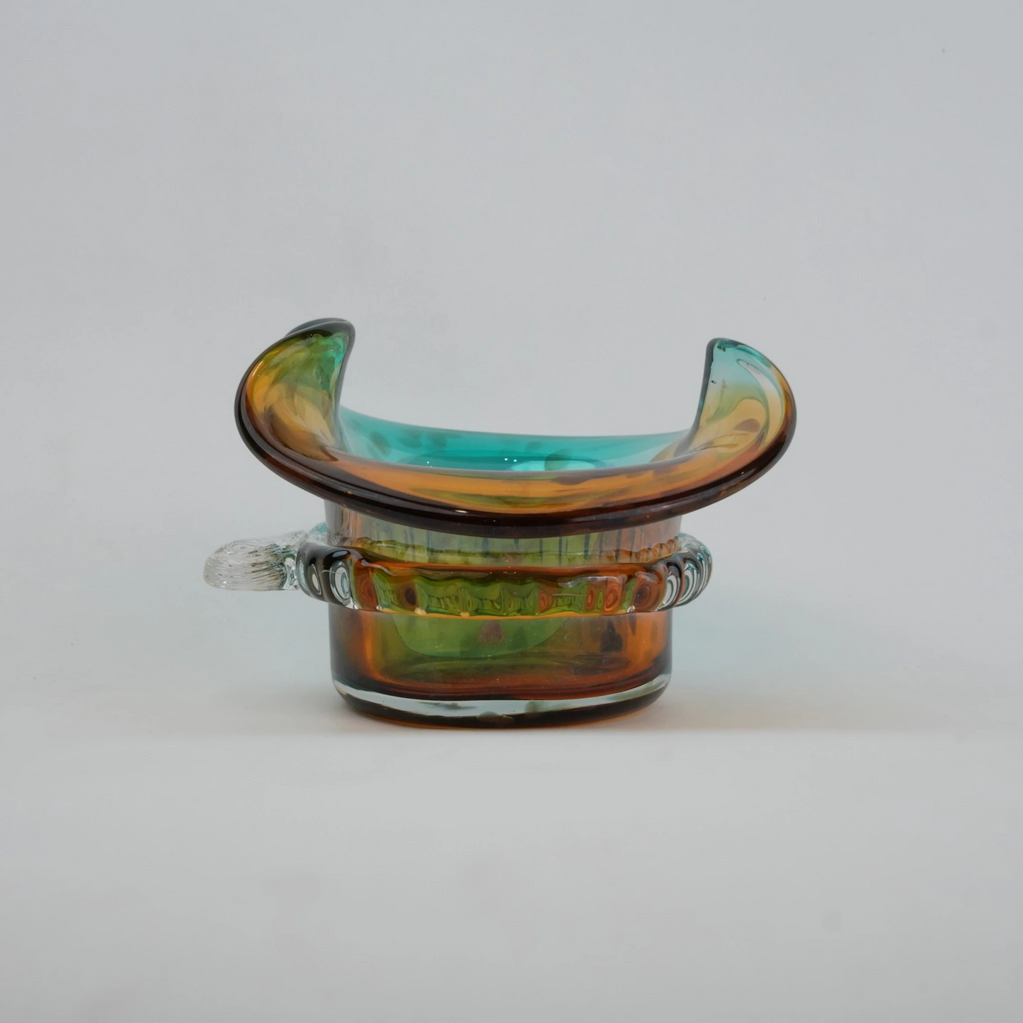 Dual-tone aqua and amber glass vase with sculptural wave-shaped rim and rounded base.