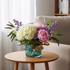 Dual-tone aqua and amber glass vase with sculptural wave-shaped rim and rounded base.