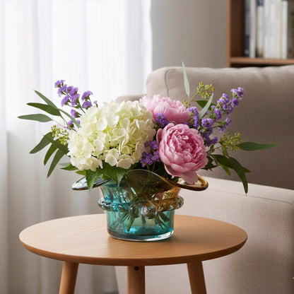 Dual-tone aqua and amber glass vase with sculptural wave-shaped rim and rounded base.