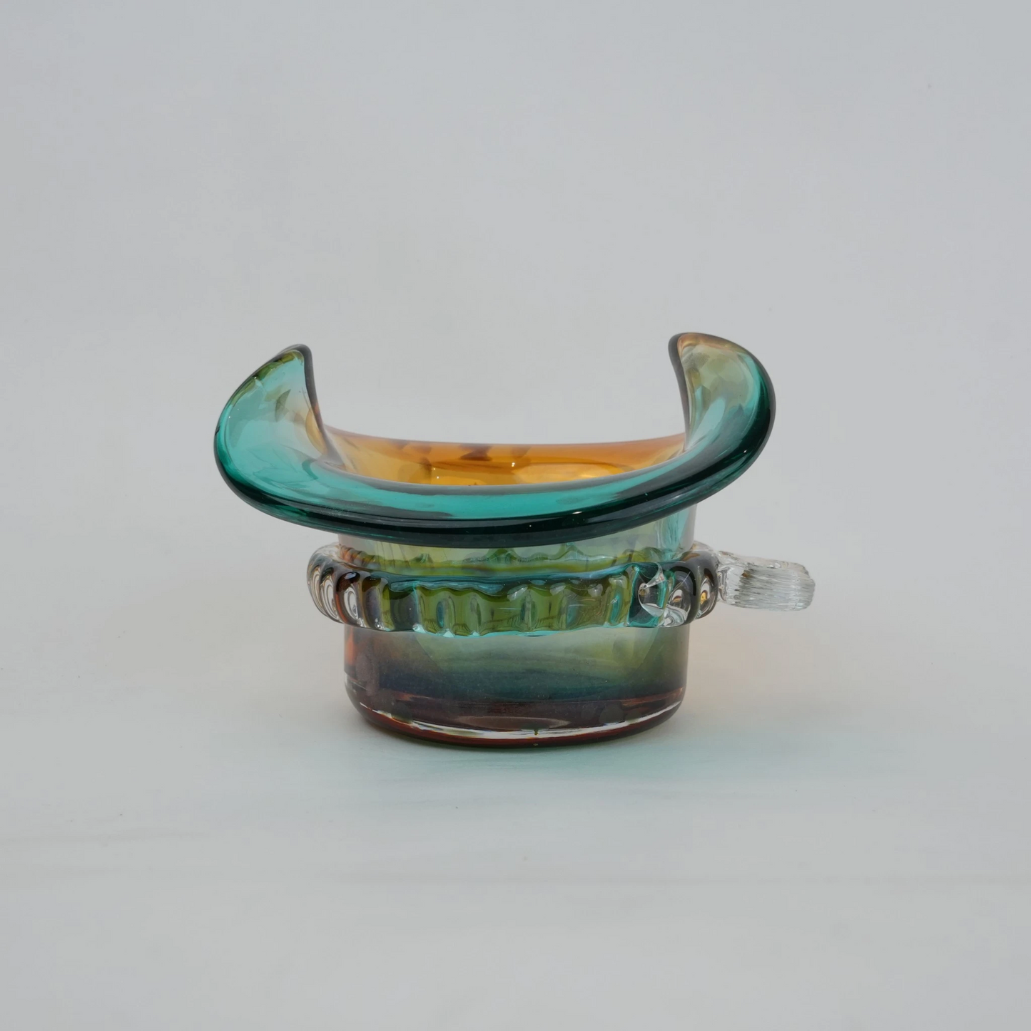 Dual-tone aqua and amber glass vase with sculptural wave-shaped rim and rounded base.