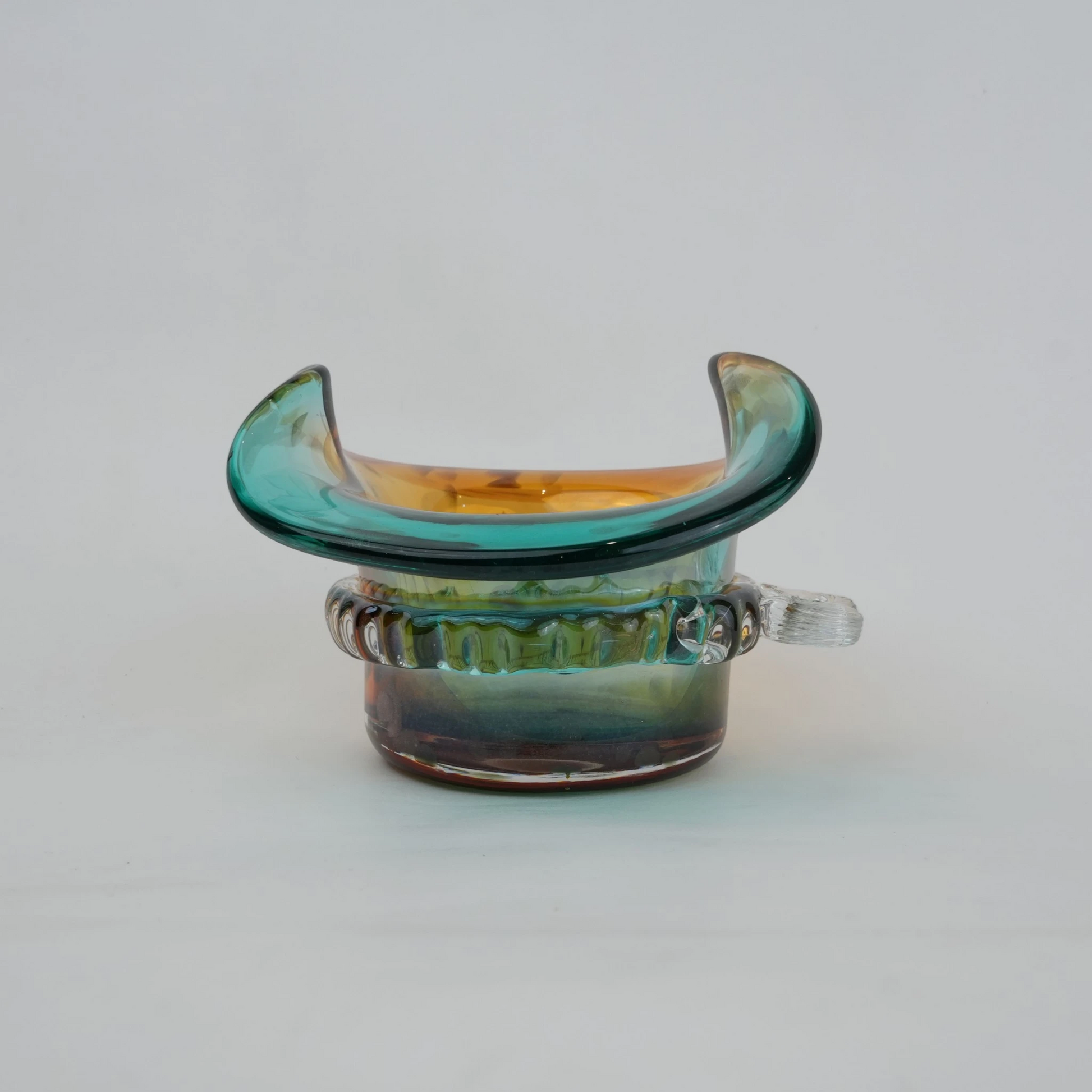 Dual-tone aqua and amber glass vase with sculptural wave-shaped rim and rounded base.