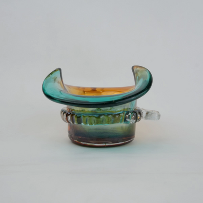 Dual-tone aqua and amber glass vase with sculptural wave-shaped rim and rounded base.