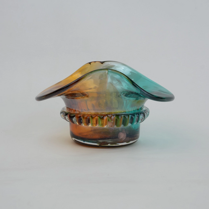 Dual-tone aqua and amber glass vase with sculptural wave-shaped rim and rounded base.