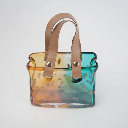 Dual-tone teal and amber glass handbag-shaped vase with bubble-textured surface and arched handle