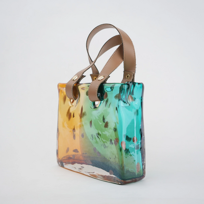 Dual-tone teal and amber glass handbag-shaped vase with bubble-textured surface and arched handle
