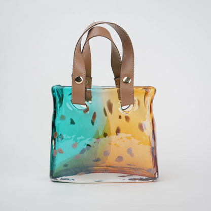 Dual-tone teal and amber glass handbag-shaped vase with bubble-textured surface and arched handle