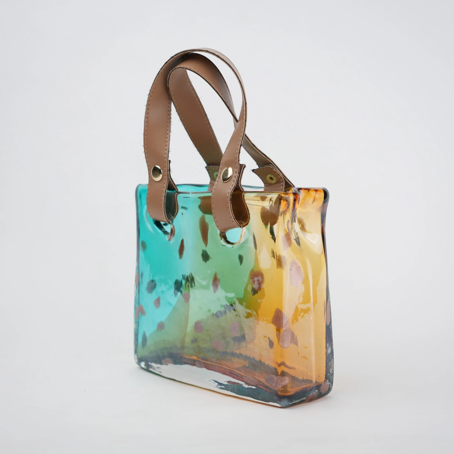 Dual-tone teal and amber glass handbag-shaped vase with bubble-textured surface and arched handle