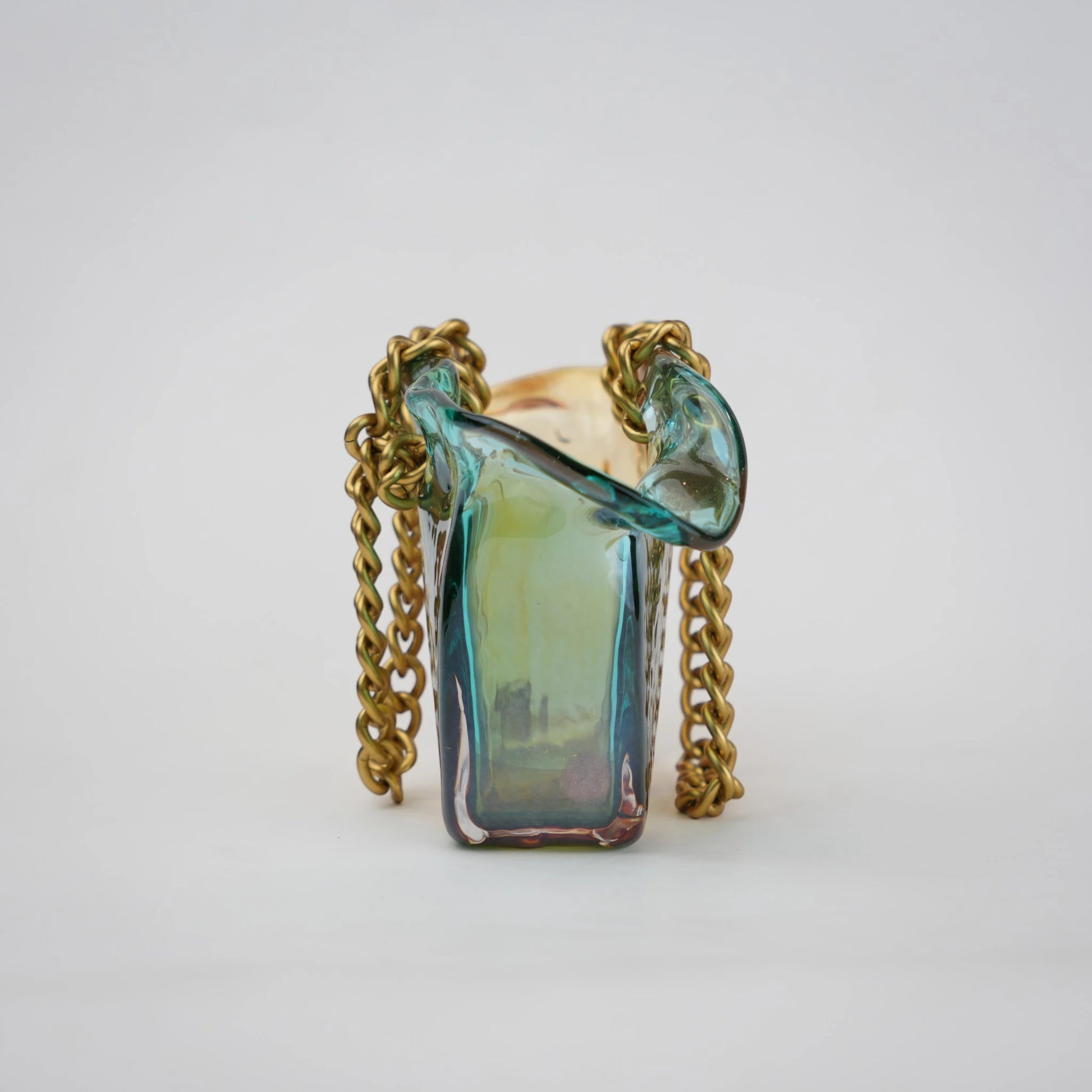 Dual-tone teal and amber glass vase with bubble texture, sculptural form, and metallic chain handle.