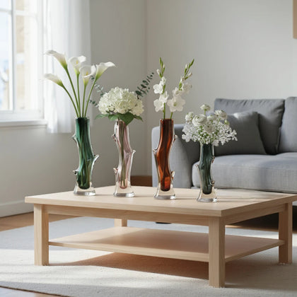 Clear glass stem vase with a branch-like shape and an inner core detail.