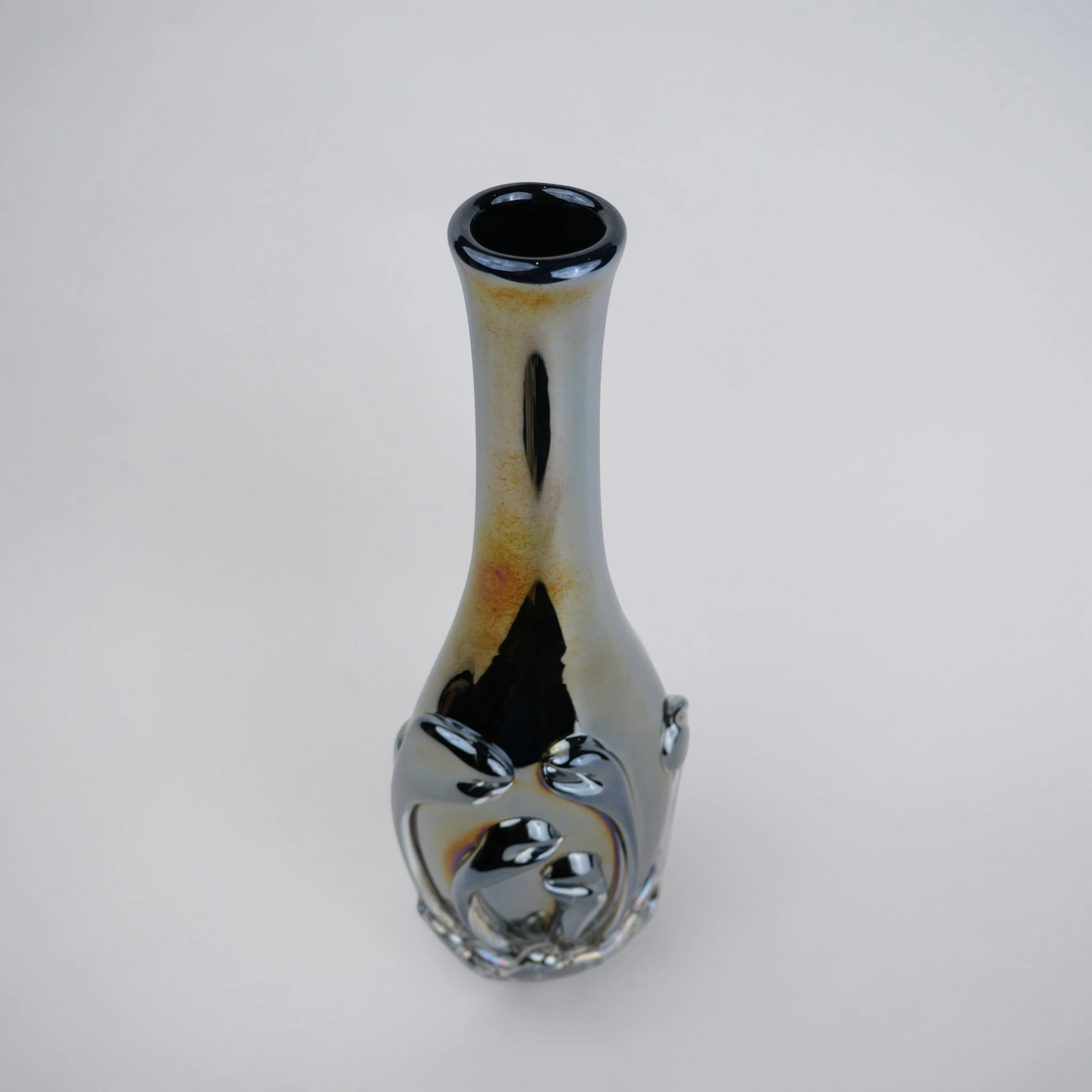 Smoked chrome iridescent glass vase with elongated neck and reflective finish.