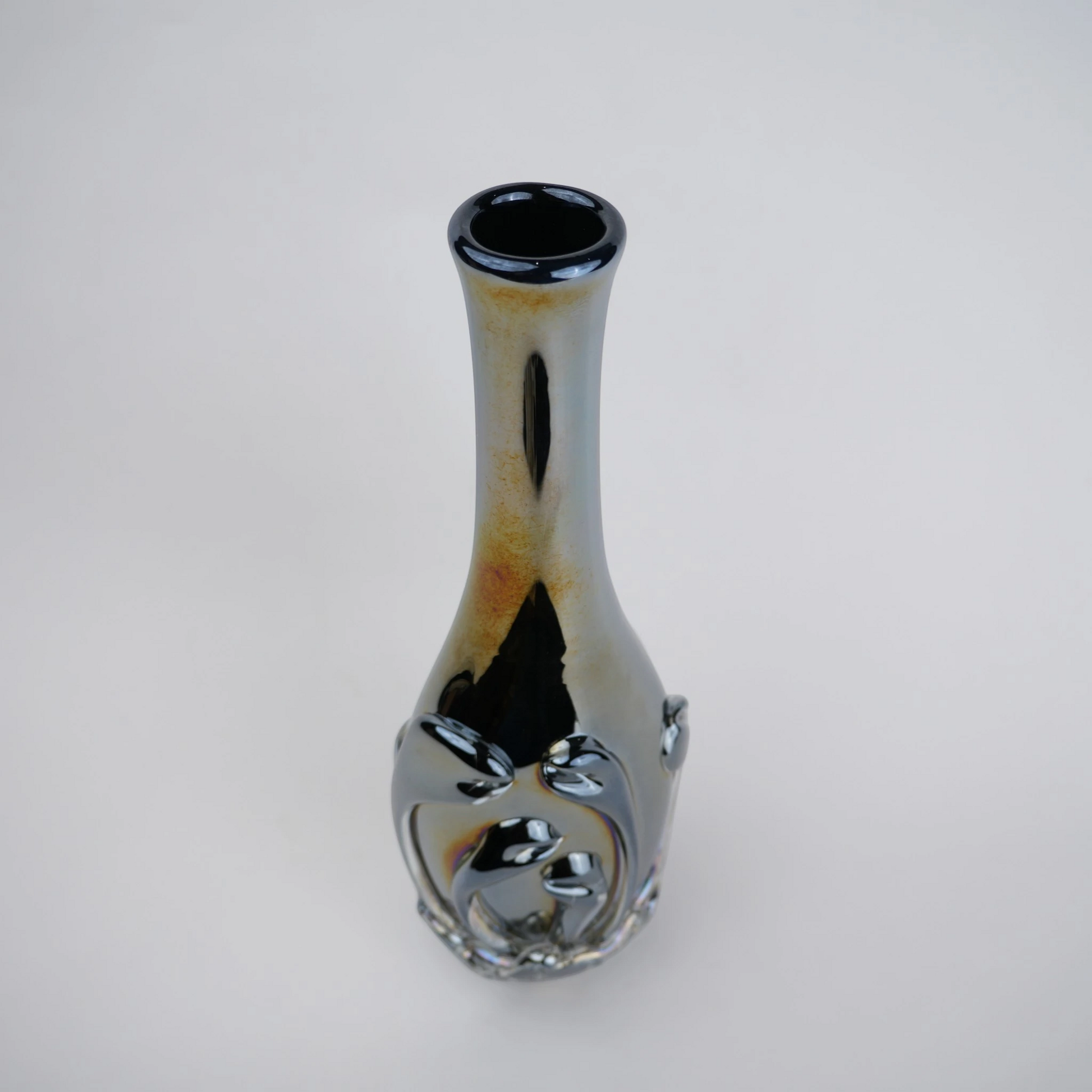 Smoked chrome iridescent glass vase with elongated neck and reflective finish.