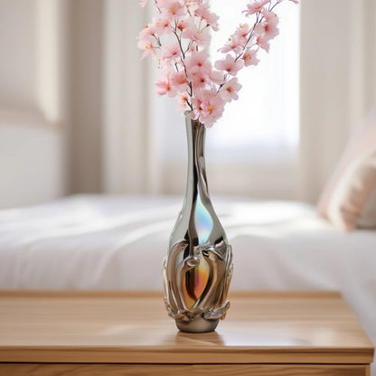Smoked chrome iridescent glass vase with elongated neck and reflective finish.