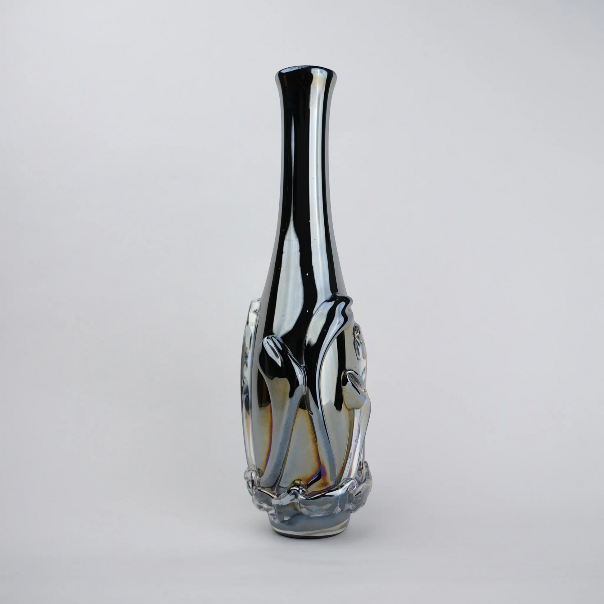 Smoked chrome iridescent glass vase with elongated neck and reflective finish.
