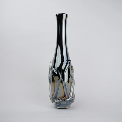 Smoked chrome iridescent glass vase with elongated neck and reflective finish.