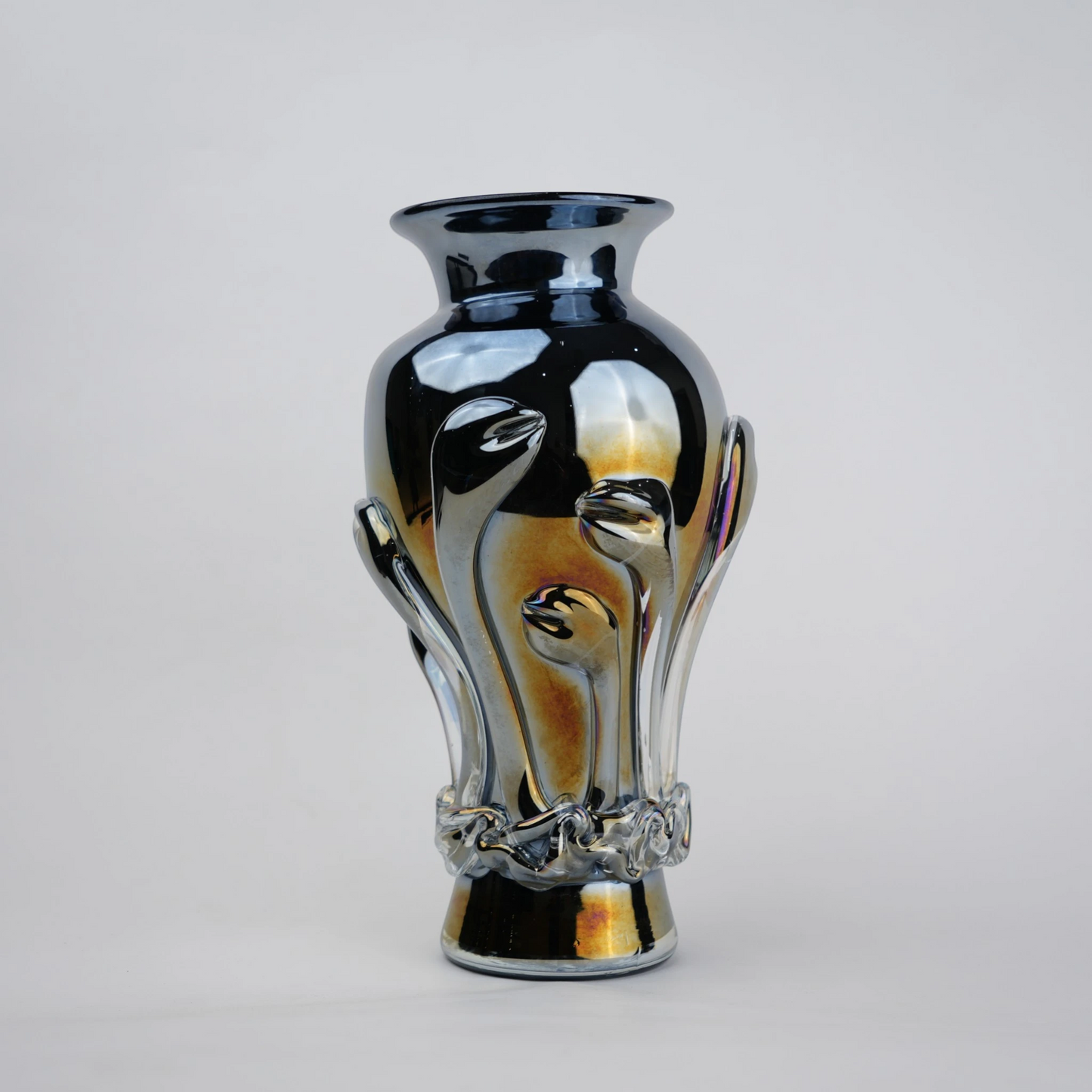 Chrome smoke reflective glass vase with curved body and metallic finish.