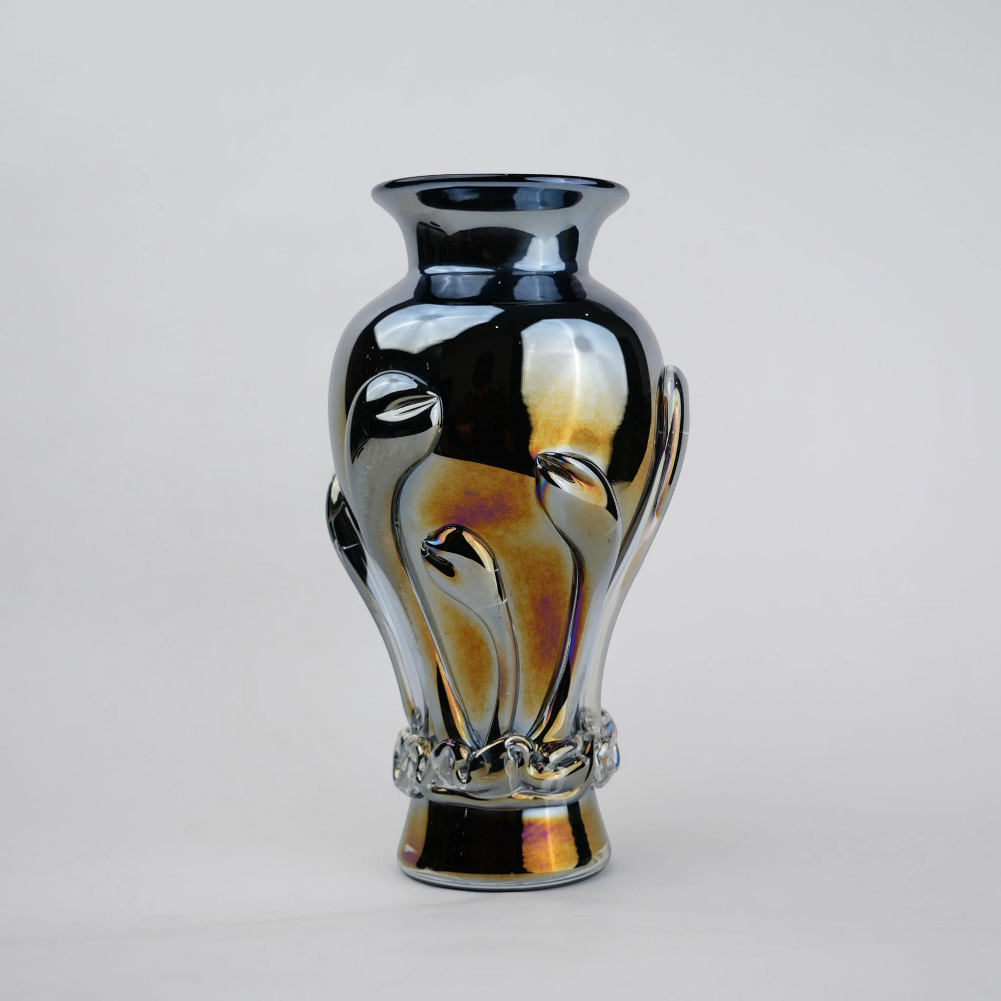 Chrome smoke reflective glass vase with curved body and metallic finish.
