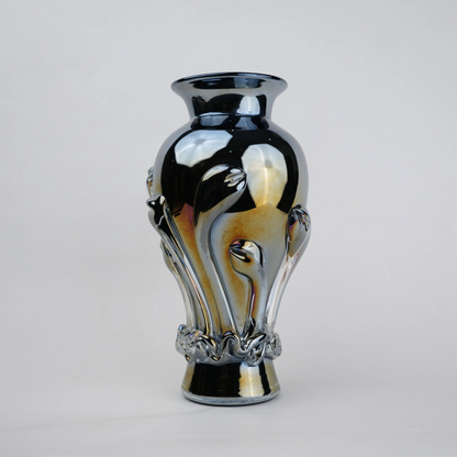 Chrome smoke reflective glass vase with curved body and metallic finish.