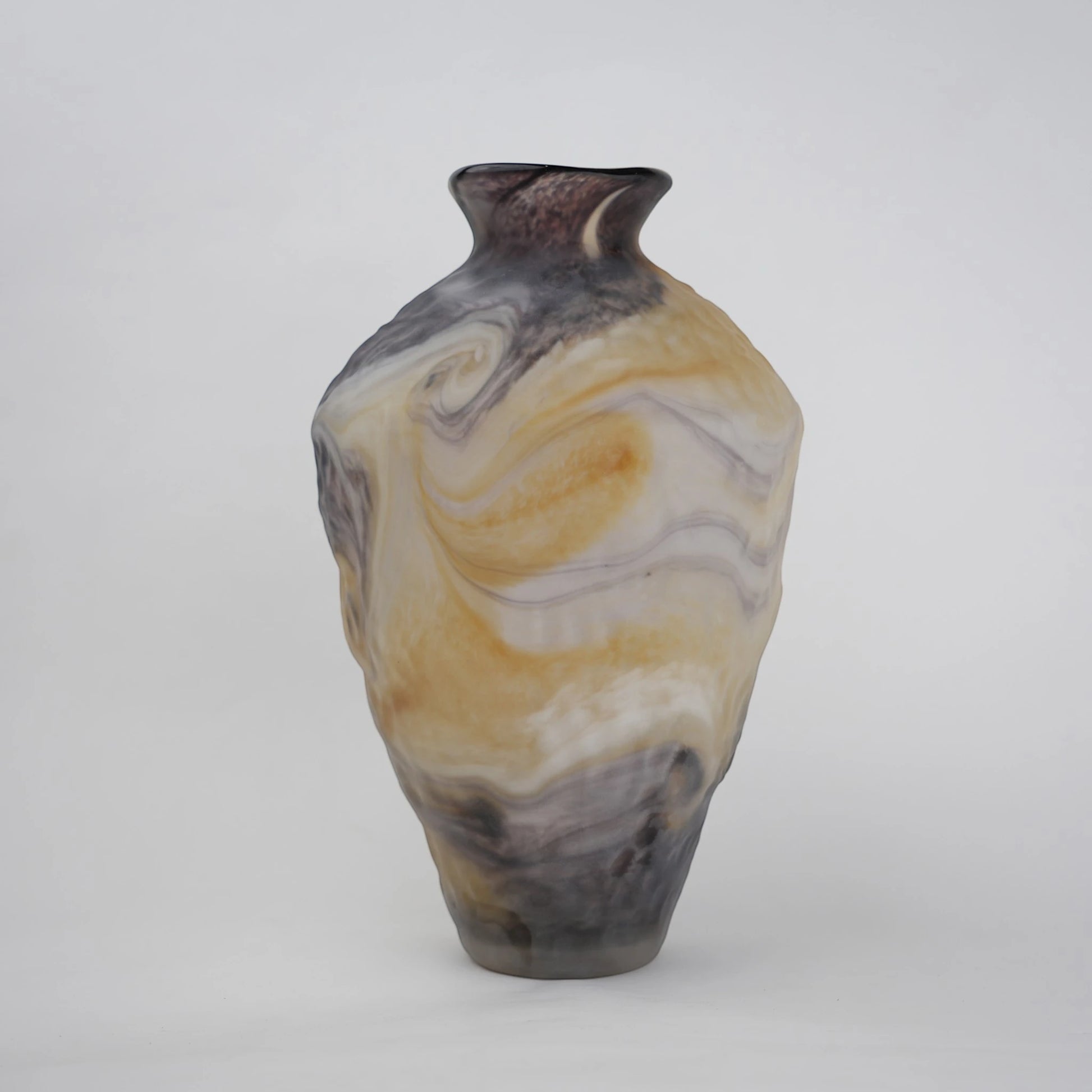 Tall white marble glass vase with flowing pattern and tapered silhouette.