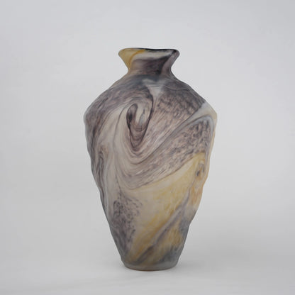 Tall white marble glass vase with flowing pattern and tapered silhouette.
