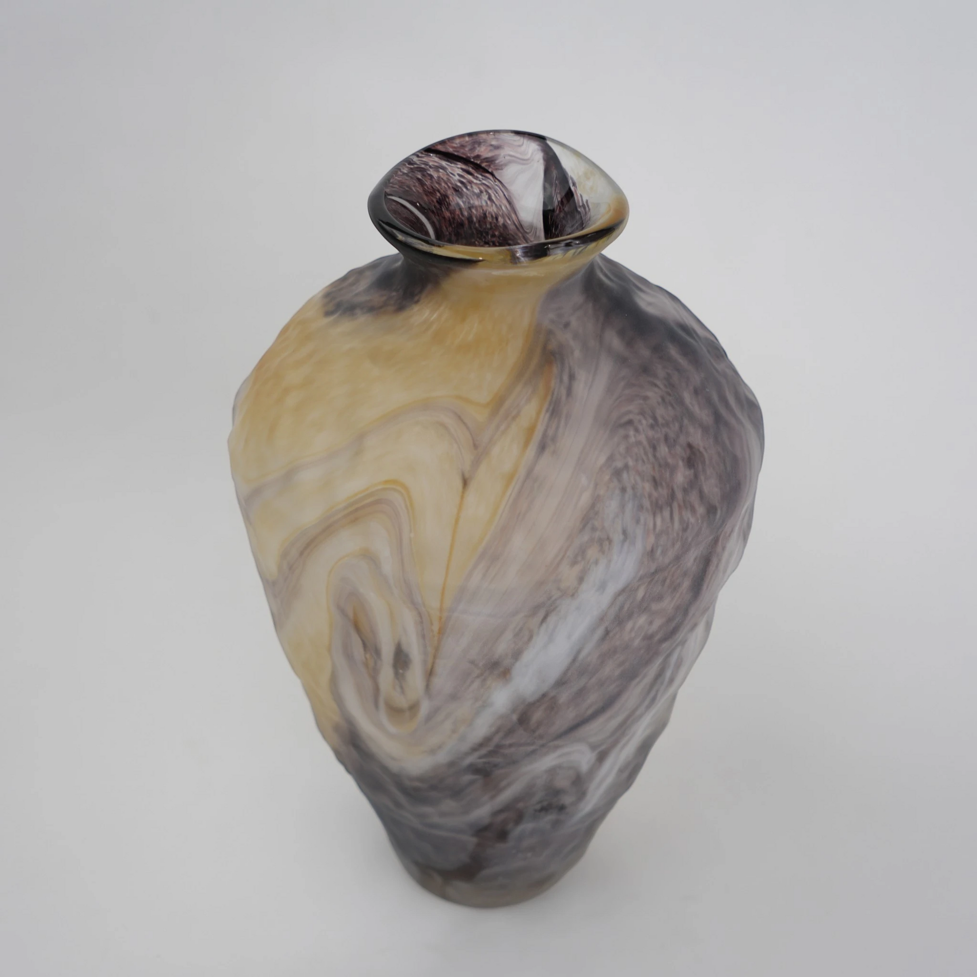 Tall white marble glass vase with flowing pattern and tapered silhouette.