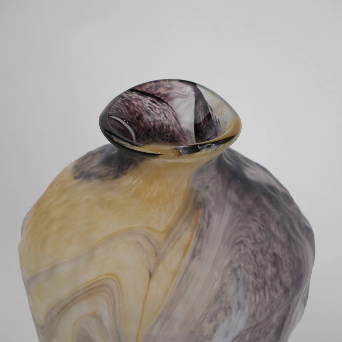 Tall white marble glass vase with flowing pattern and tapered silhouette.