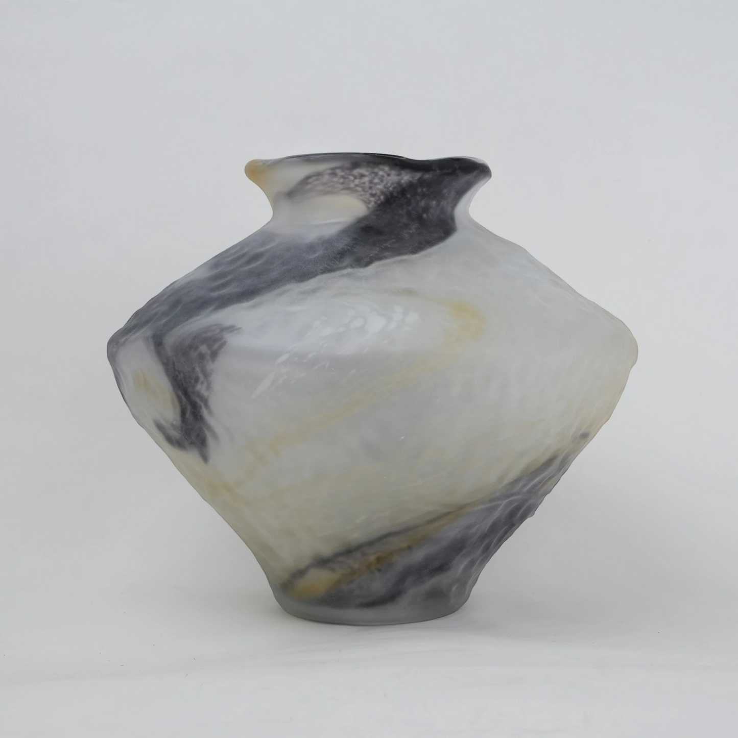 White marble art glass vase with organic pattern and wide asymmetrical form.